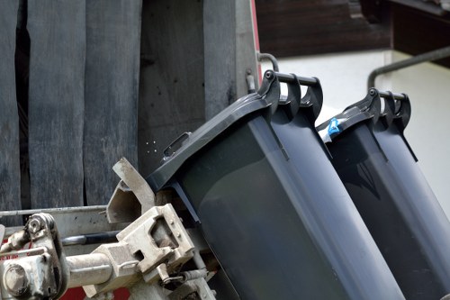 Professional waste collectors removing furniture items
